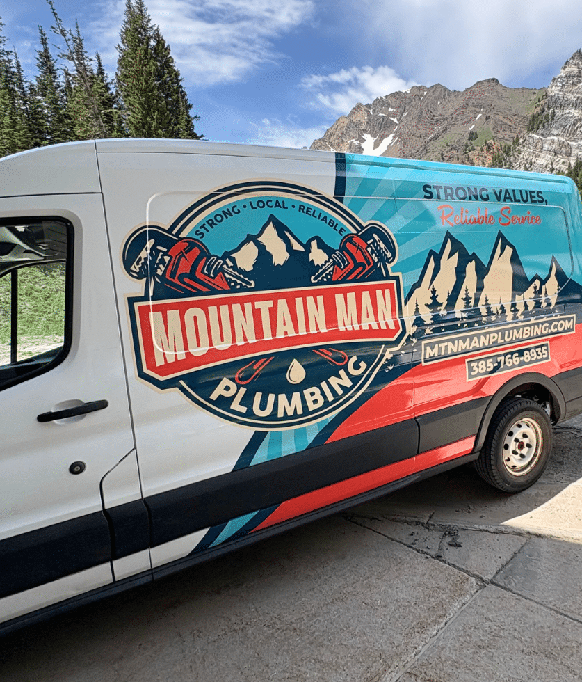Mountain Man Plumbing service van with the company name and mountain graphics