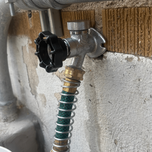 Outdoor hose bib installation on a brick home in Sugar House, Utah. Brass spigot with clean threading, mounted securely to siding.