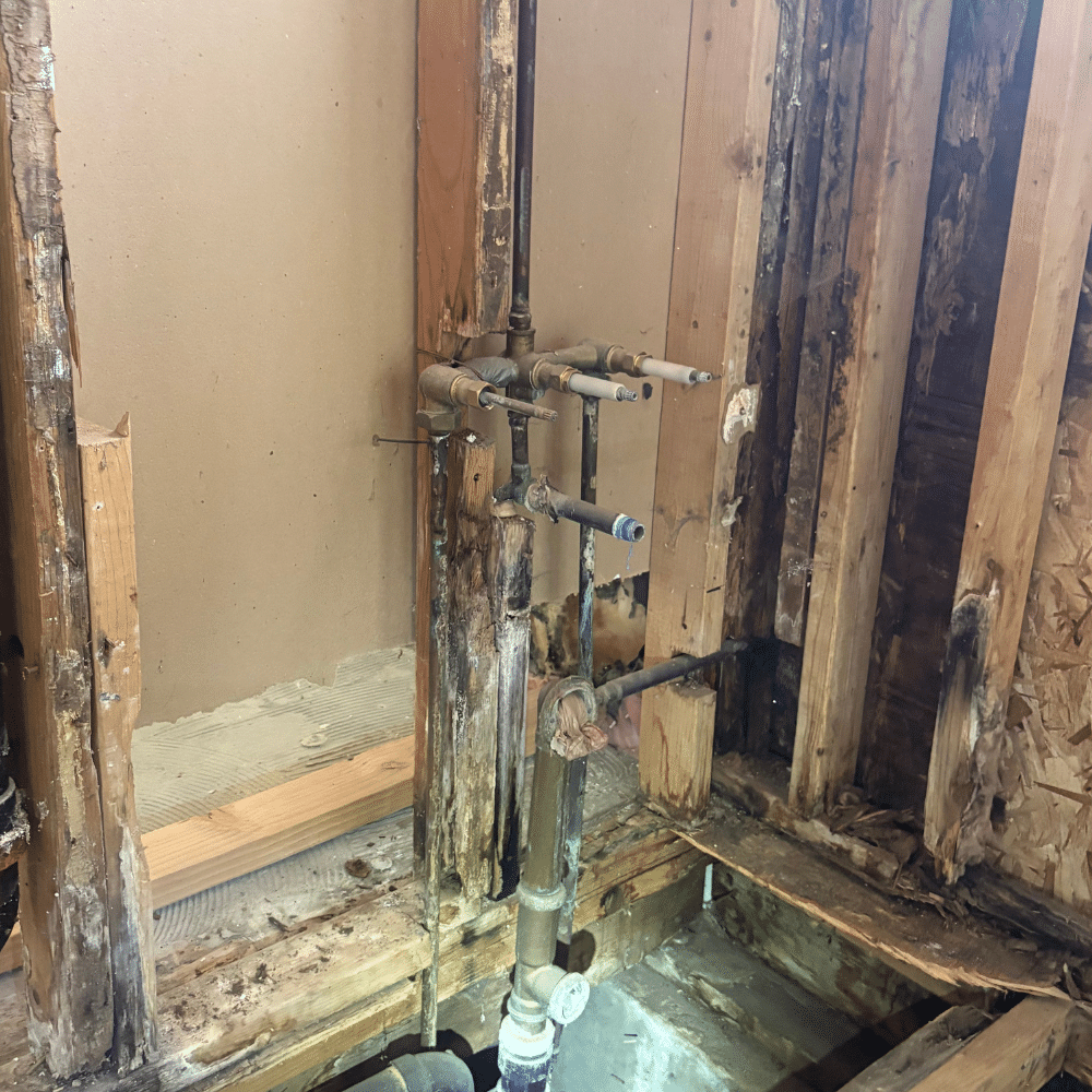 Damaged original shower valve plumbing in Holladay, Utah before professional replacement by Mountain Man Plumbing.