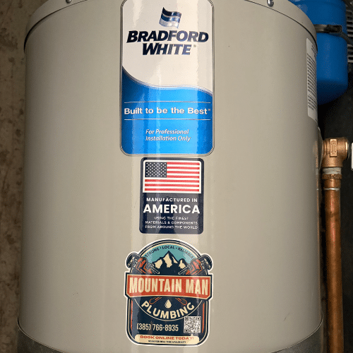 Close-up of Bradford White water heater label with Mountain Man Plumbing branding
