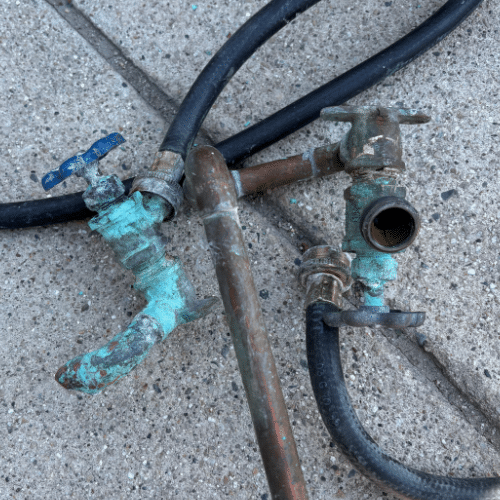 Removed damaged plumbing components during basement leak repair in Sandy, Utah.