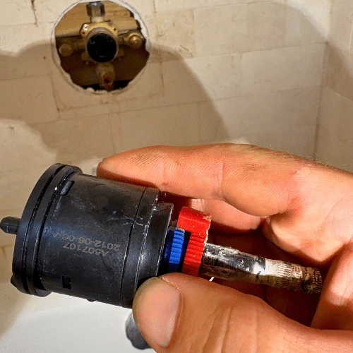 Salt Lake City shower repair inspecting damaged shower valve before replacement
