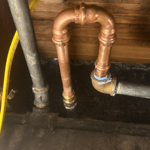 Outdoor hose bib installation on a brick home in Sugar House, Utah. Brass spigot with clean threading, mounted securely to siding.