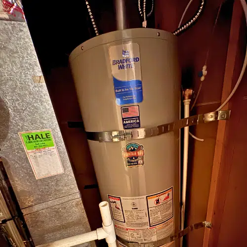 Code-compliant seismic strapping on a new water heater in West Valley City.