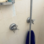 Failed shower valve stems removed during a completed shower repair in Midvale, Utah