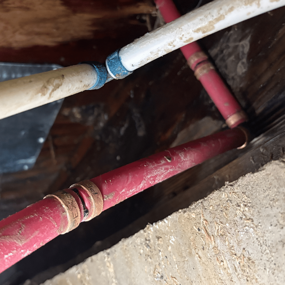 Crawlspace access during a completed PEX leak repair in Murray, Utah