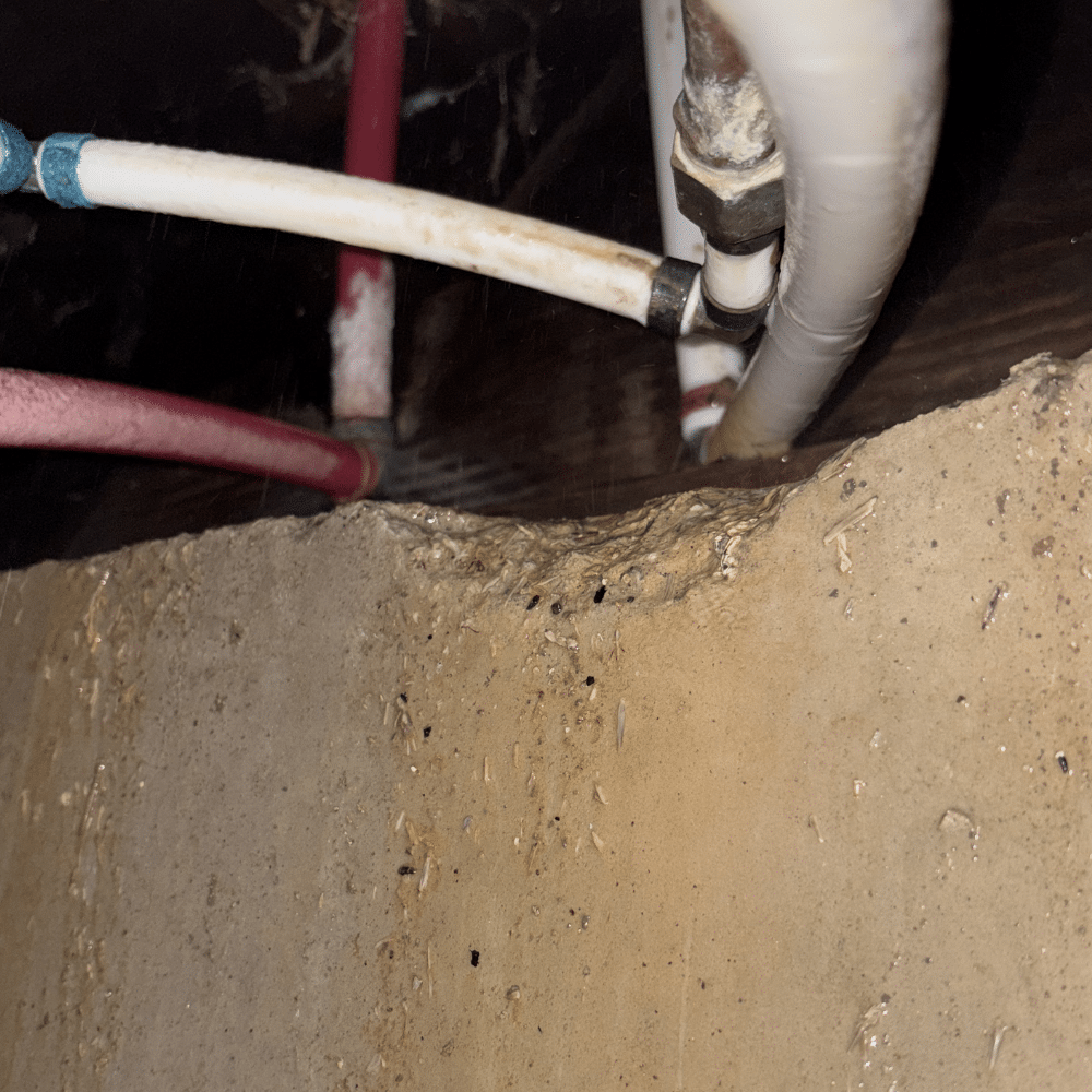 Crawlspace access during a completed PEX leak repair in Murray, Utah