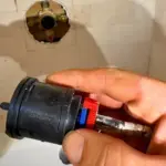 Salt Lake City shower repair inspecting damaged shower valve before replacement