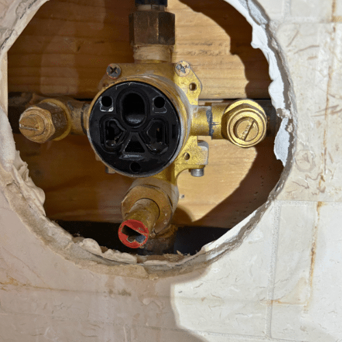 Salt Lake City shower repair inspecting damaged shower valve before replacement