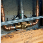 Sealing and finishing repaired shower handle trim during a shower repair in Sandy Utah