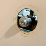 Sealing and finishing repaired shower handle trim during a shower repair in Sandy Utah