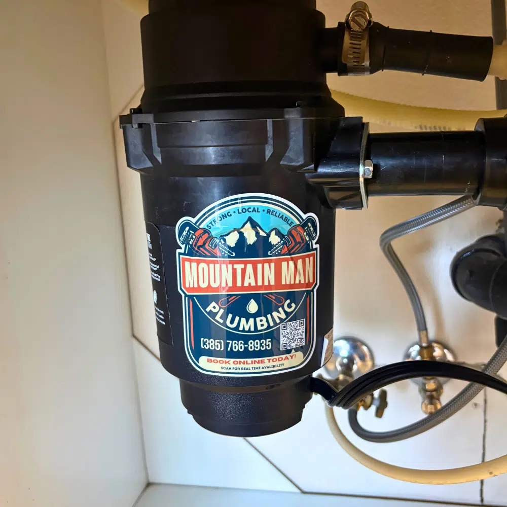Garbage disposal installation under kitchen sink in West Valley City Utah