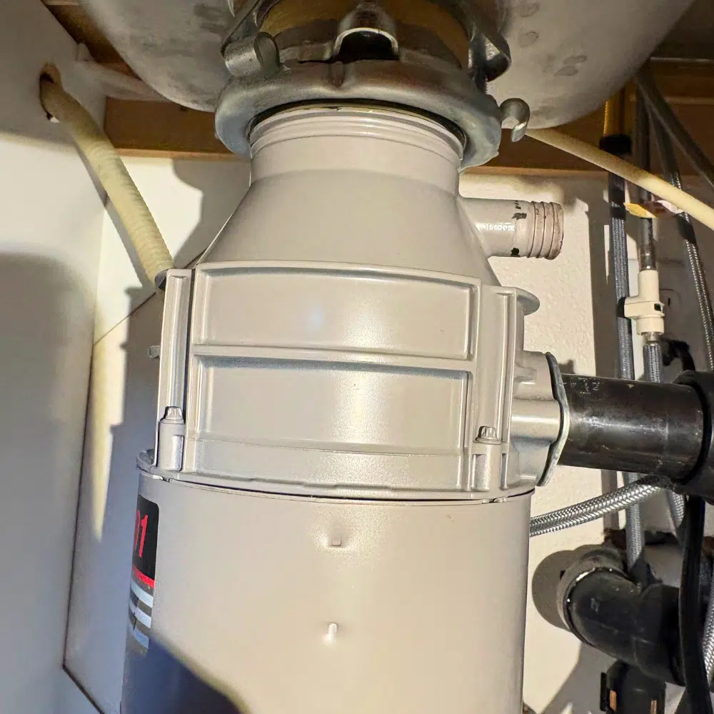 Garbage disposal installation under kitchen sink in West Valley City Utah