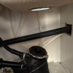 Under-sink garbage disposal mounting ring and disposer body at the sink flange before bracket hardware replacement in Salt Lake City.