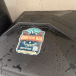 Mountain Man Plumbing sticker on new black brine tank lid after completed Millcreek water softener installation.