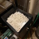 Open brine tank filled with white salt pellets for water softener regeneration in Park City