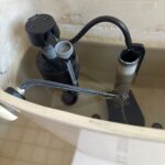 Open toilet tank with new Fluidmaster-style fill valve installed and refill tube set after running-toilet repair in Salt Lake City.