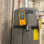 Crew cleaning water heater burner and replacing gas valve — detail photo 5