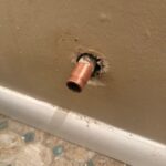 Bare copper water supply stub protruding from the bathroom wall before new shutoff valve install in West Jordan