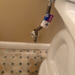 Braided toilet supply line connected from new wall shutoff to the tank fill valve in West Jordan bathroom