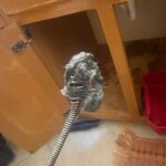 Hair and debris mass on a drain cable after clearing a clogged bathroom sink in Millcreek Utah.