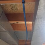 Blue PEX line secured along basement framing between metal ductwork after polybutylene replacement Sandy