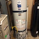 Full view of new 40-gallon Bradford White water heater on drain pan with gas line and T&P piping in Bountiful basement