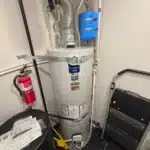 New gray Bradford White tank water heater installed with seismic straps, vent, and expansion tank in North Salt Lake utility space.