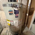 Bradford White power vent water heater with Mountain Man Plumbing sticker, seismic strap, and gas connection in South Jordan utility space