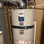 Bradford White 40-gallon water heater with earthquake strap, expansion tank above, and Mountain Man Plumbing label in Bountiful UT utility space