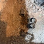 Deep gravel pit with pipe ends and stainless couplings ready for backwater valve tie-in in Draper.