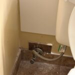 White interior access panel installed beside toilet supply after hose bib wall work in Draper Utah