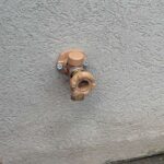 New tan frost-free outdoor hose bib mounted on exterior stucco wall after replacement service in Draper Utah