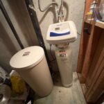 North Star softener mineral tank and brine tank installed on a basement floor with control head and flexible supply lines in Draper.