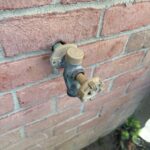 Outdoor frost-free hose bib mounted through brick exterior wall after replacement service in Sandy Utah