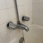 Reinstalled chrome diverter tub spout with outside riser and dual handles working on Salt Lake City tub wall