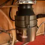 InSinkErator Badger 5 disposal fully mounted under the sink with brand badge visible after Midvale service.