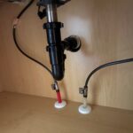 New quarter-turn shutoff valves and supply lines under bathroom sink cabinet in Midway UT home