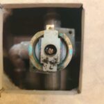 Worn Moen Posey shower cartridge exposed in Salt Lake City valve after handle failure, ready for standard replacement.