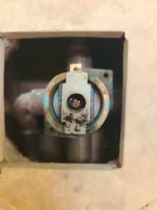 Worn Moen Posey shower cartridge exposed in Salt Lake City valve after handle failure, ready for standard replacement.