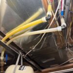 Overhead PEX and CSST lines with expansion tank near metal ducting above the water heater space in South Jordan