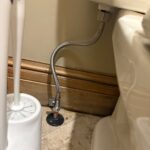 New quarter-turn toilet shutoff valve and braided supply line installed beside the toilet tank in a Park City bathroom