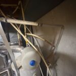 Cream polybutylene supply lines above water heater and expansion tank before full replacement Sandy Utah