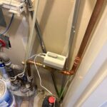 Resideo L5 Wi-Fi actuator on copper water line near heater piping in South Salt Lake condo mechanical space