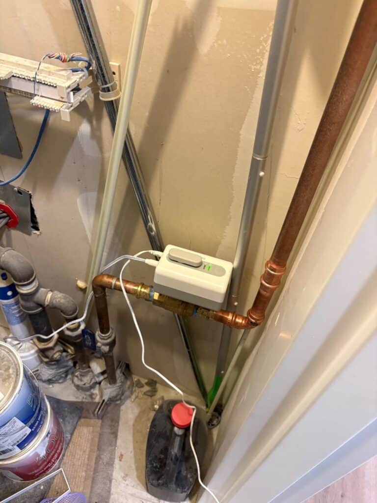 Resideo L5 Wi-Fi actuator on copper water line near heater piping in South Salt Lake condo mechanical space