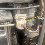 Close-up of Rinnai flame sensing area connectors and gas components after service in Salt Lake City Utah