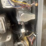 Gas valve and wiring harness inside a Rinnai tankless water heater during burner service in Salt Lake City Utah